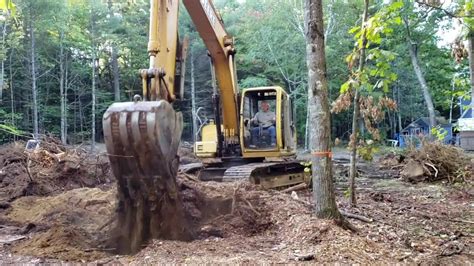 pulling out stumps with excavator